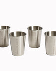 Set of four sleek, stainless steel shot glasses with a brushed finish and ’kingsley & harper’ engraved vertically along the side.