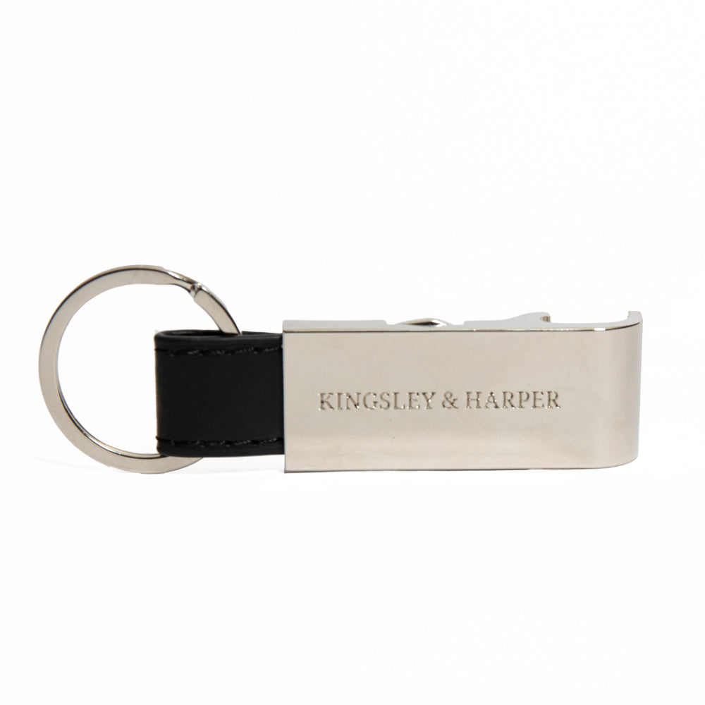 Keychain with black leather strap and metallic tag displaying 'Kingsley & Harper' on a white background