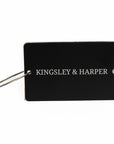 Black rectangular luggage tag with silver lettering from The Globetrotter Travel Set