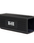 Black silicone pet hair remover with a textured surface and ’k&h’ logo.