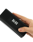 Black k&h pet grooming brush with a textured, rubberized handle and stiff bristles.