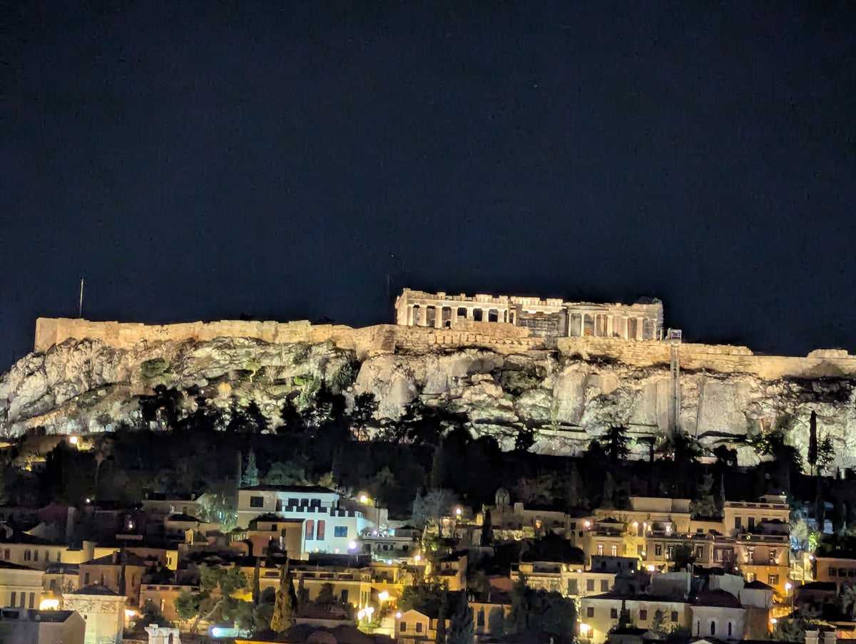 Illuminated Parthenon temple in Athens, ancient Greek columns at night