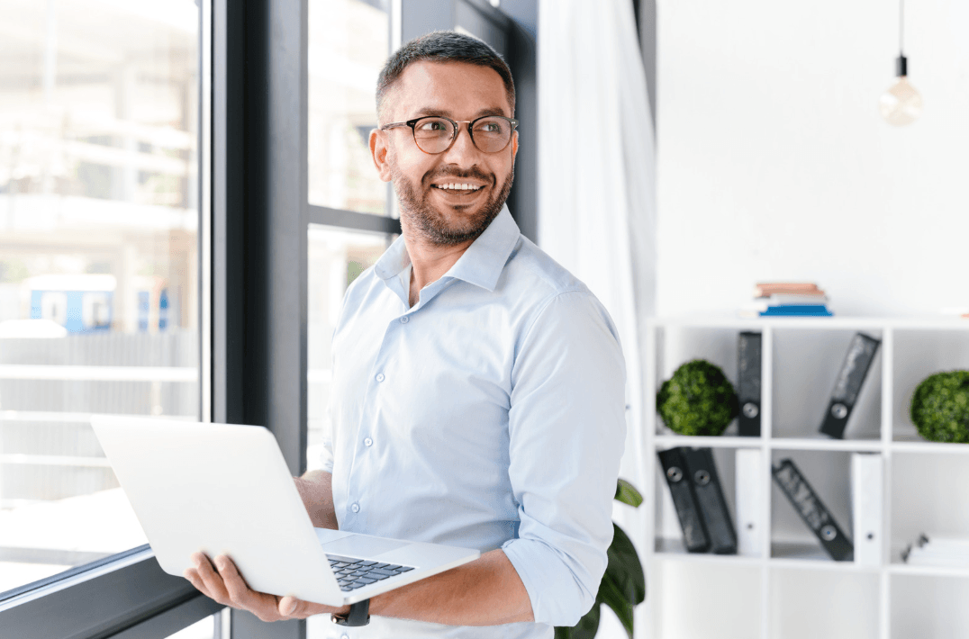 Man at work with laptop smiling