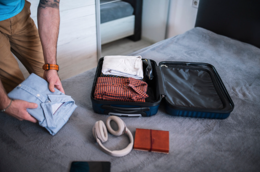 man packing suitcase