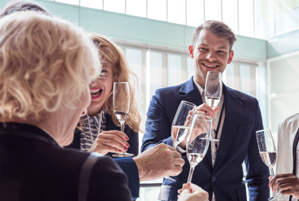men at work leaving party drinking champagne