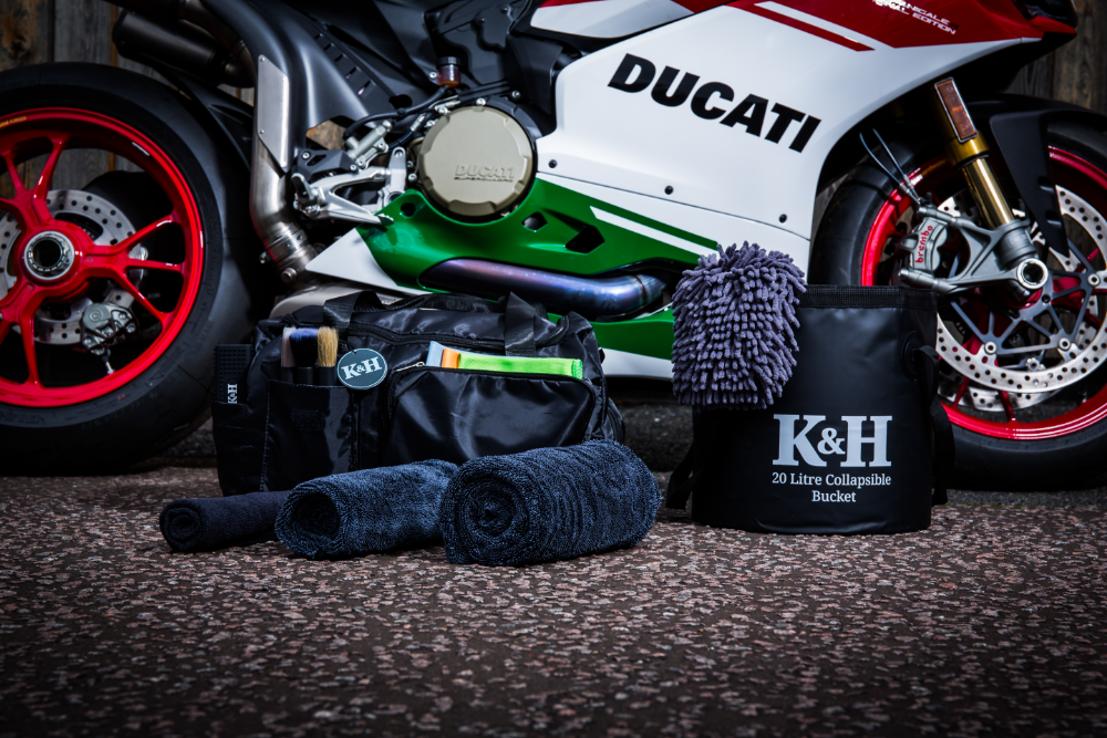 Ducati motorcycle with K&H The Detailer Car Cleaning Set on a textured surface