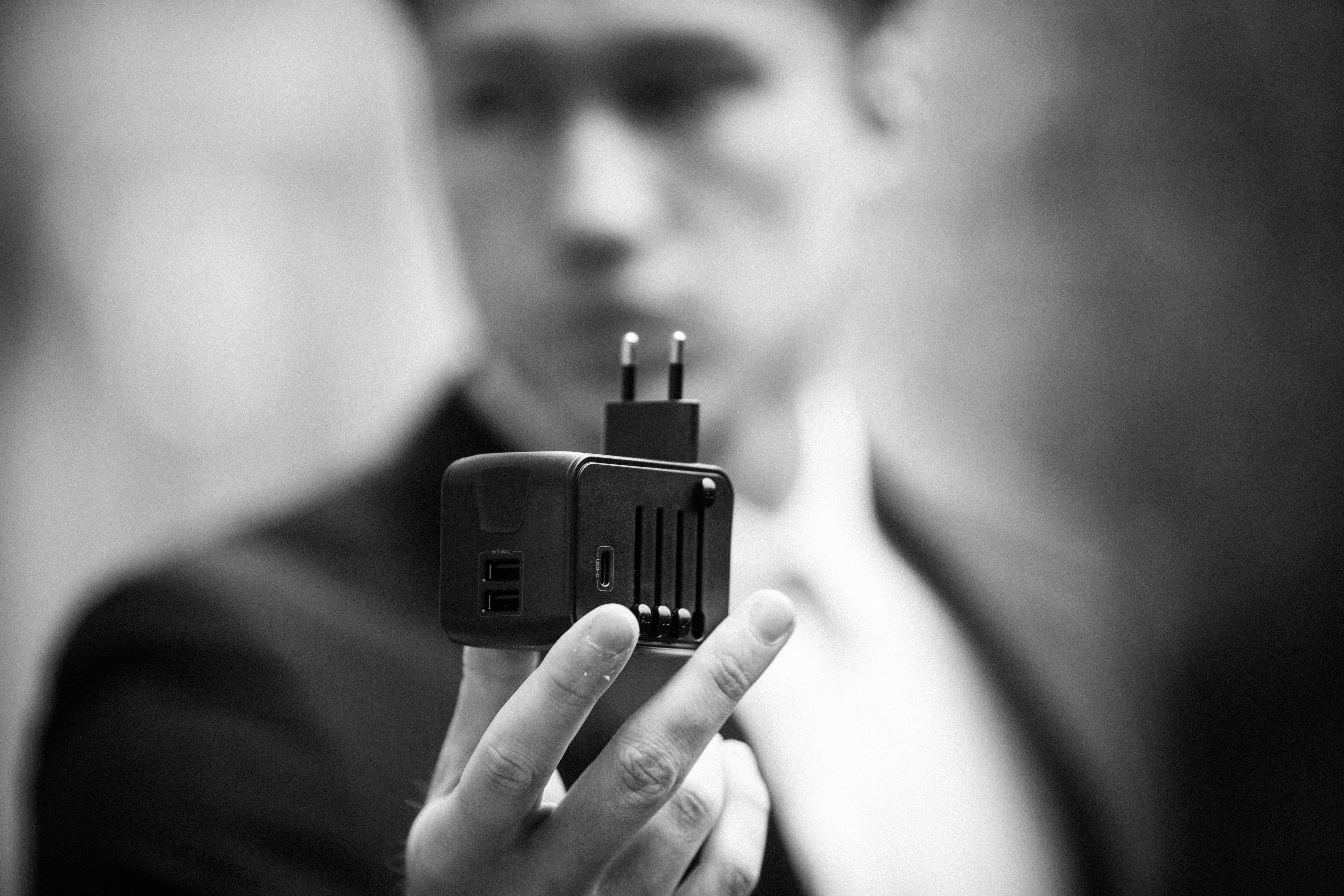 Black compact travel adapter with dual usb ports and a european-style plug