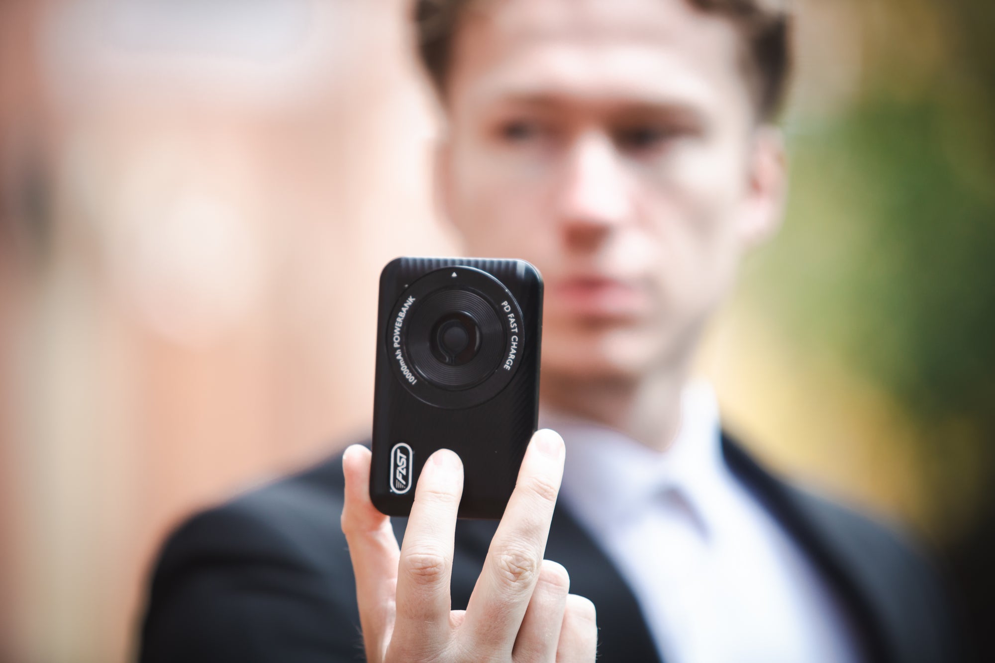 Black compact action camera with a circular lens and ’1080p hd camera’ text around it, featuring the zhiyuan brand logo on its side.