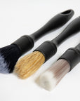 Three cleaning brushes with different bristle types included in The Detailer Car Cleaning Set on a white background