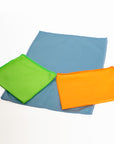 Three colorful cloths (green, blue, orange) on a white background